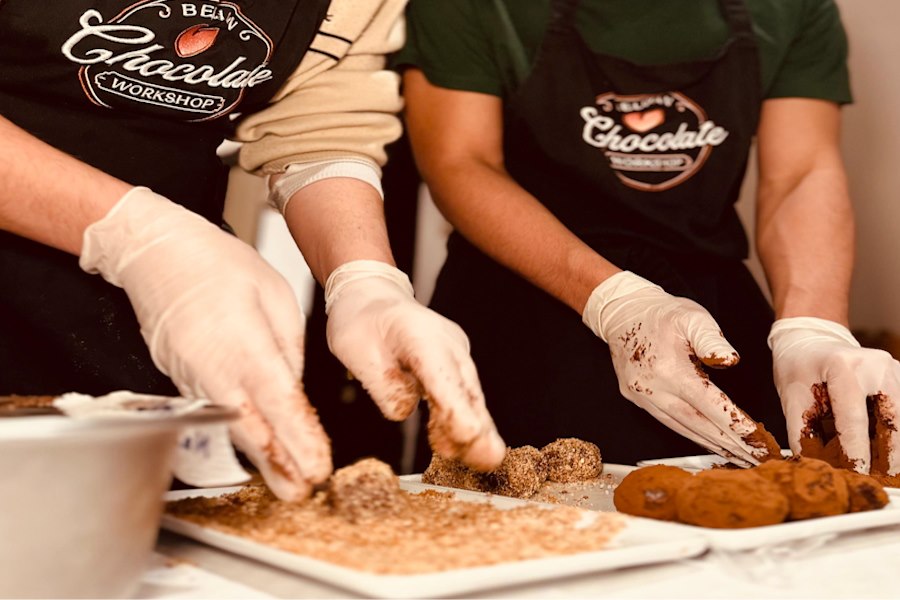 people making chocolate truffles in brussels at the workshop